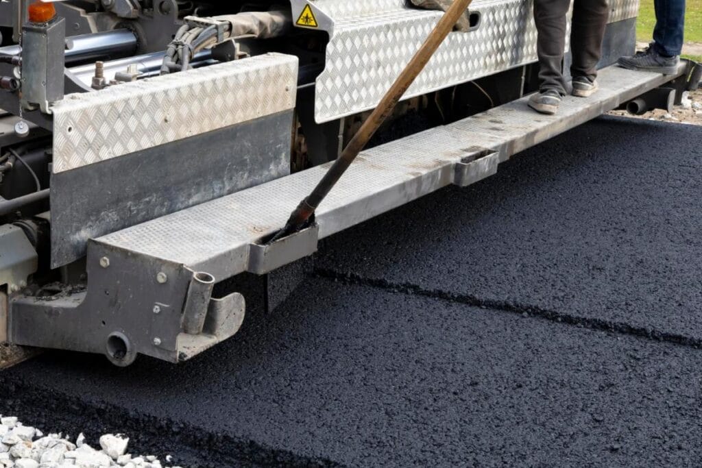 Contact 67 asphalt paver machine during road construction repairing works