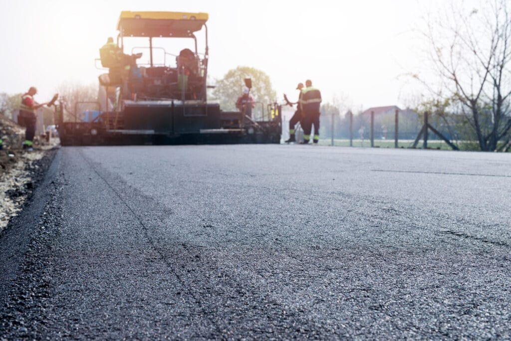 Understanding Different Types of Seal Coats 17 workers placing new coating asphalt road 1